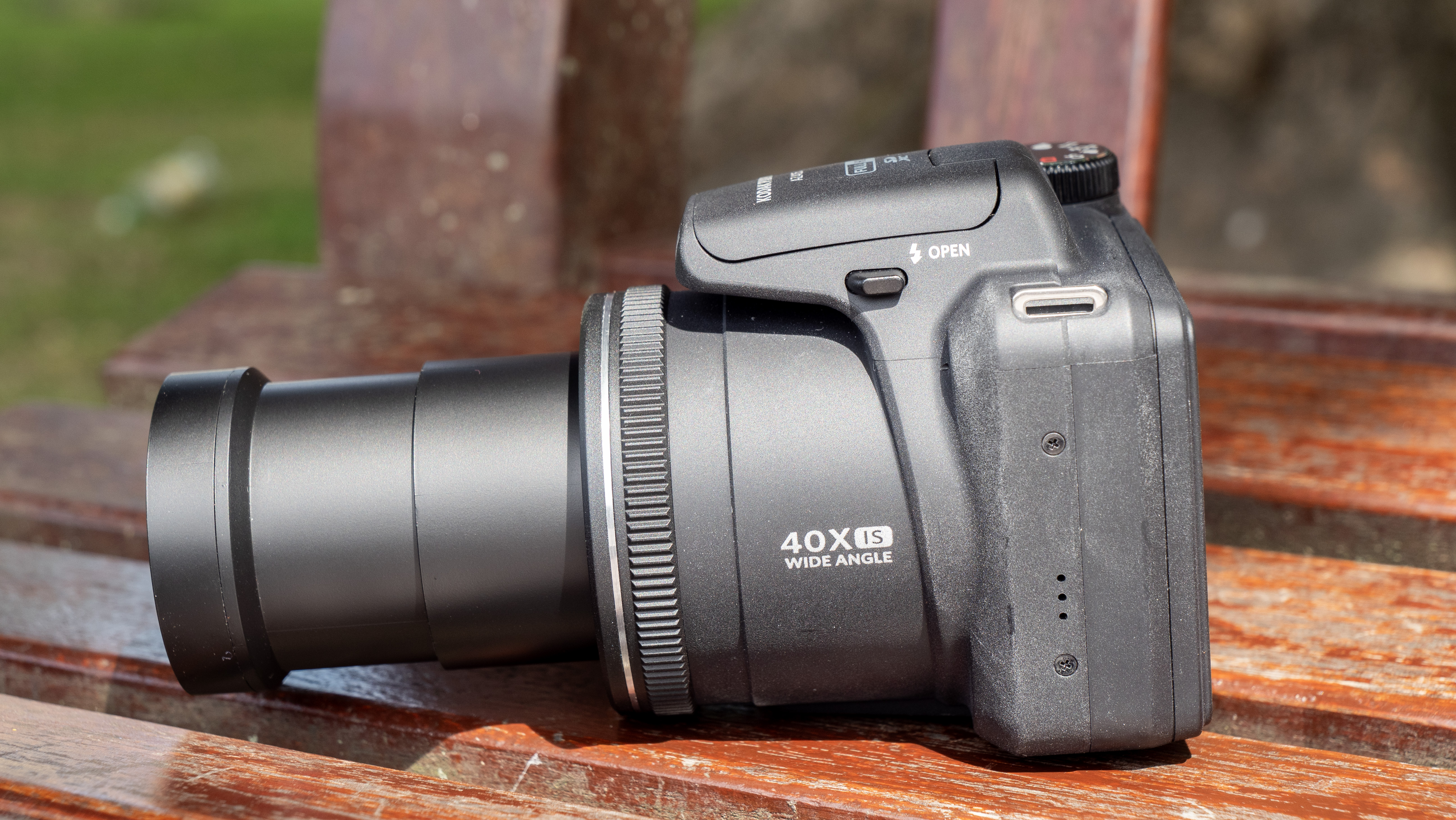 Kodak PixPro AZ405 digital camera in black on a wooden slatted table