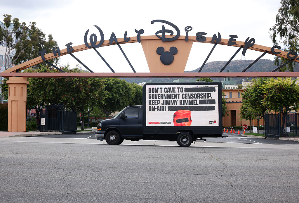 Walt Disney studios and a sign urging it not to cave into demands for censor Jimmy Kimmel