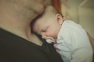 baby sleeping on father's chest