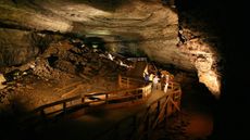 A park ranger talks with Mammoth Cave visitors in Broadway, one of the cave's canyon passages.