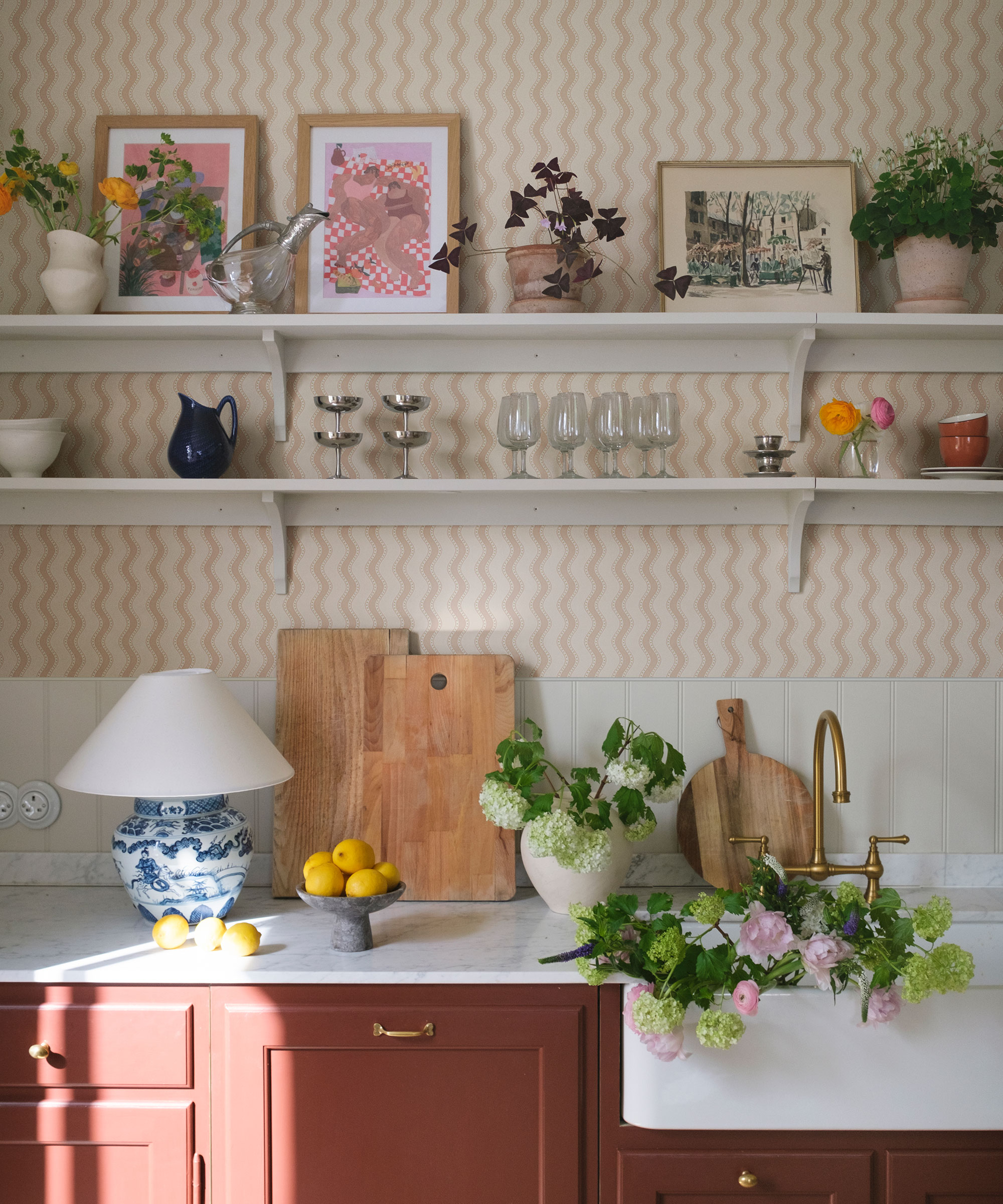 red utility room with dusky pink wavy striped wallpaper and white shelving