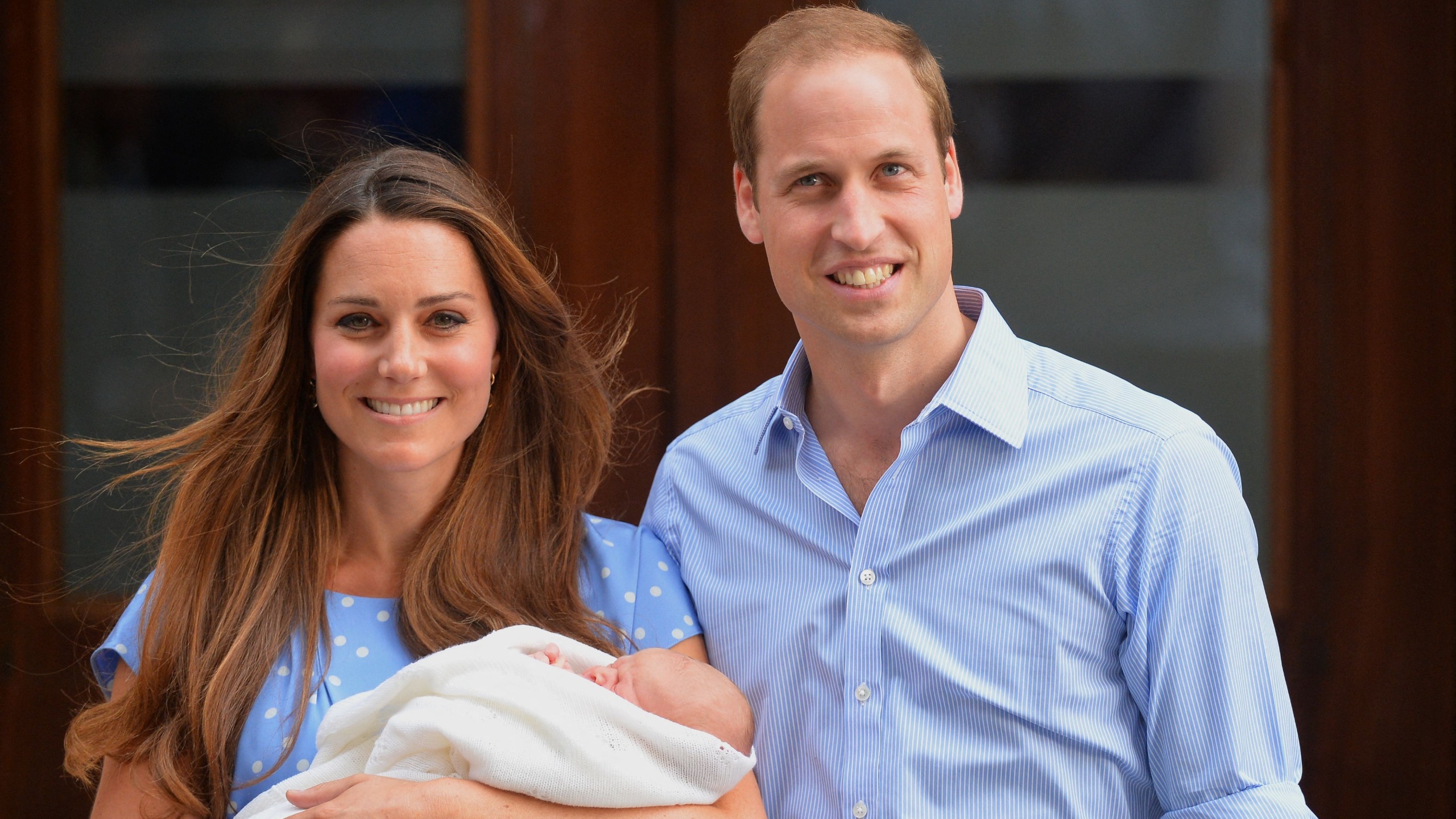 Prince William and Catherine, Princess of Wales (holding baby George) standing on the steps outside the Lindo Wing of St Mary's Hospital in London on July 23, 2013