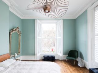 A light blue wall with white historic trim