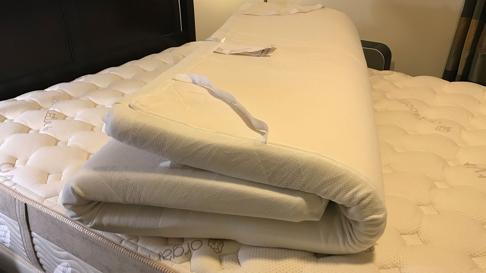 A Tempur-Pedic TEMPUR-Adapt Mattress Topper folded up