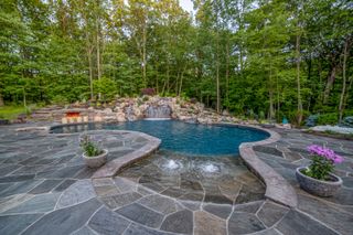 large curved swimming pool in an American backyard