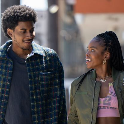 Michael Cooper Jr. as Justin Edwards and Lovie Simone as Keisha Clark walking through los angeles and smiling at each other in the tv show forever