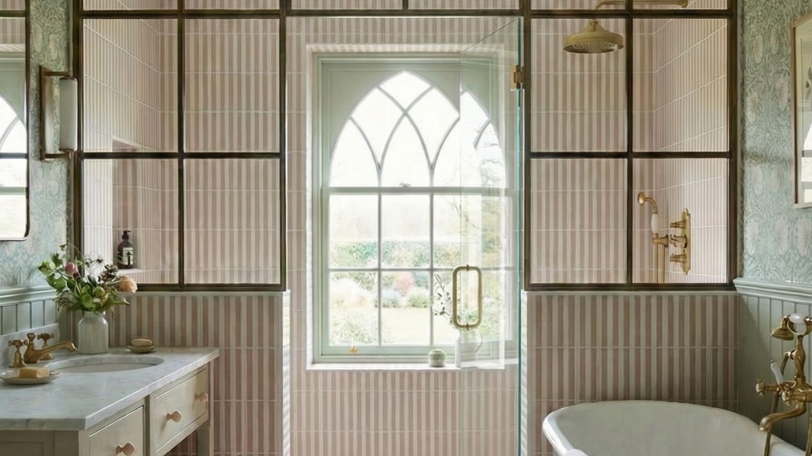 A large bathroom covered in pink and white tiles in a stripe layout