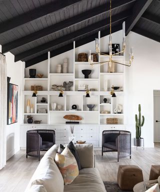 Bespoke whtie open shelving ceiling to floor in living room space