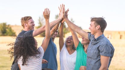 A family gives one another a big high five.