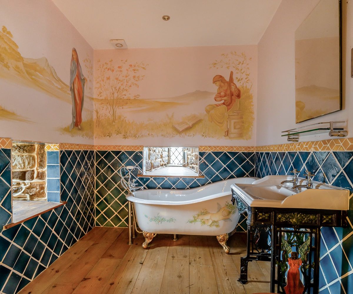 An en suite bathroom with wall murals