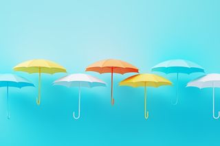 Colorful umbrellas on blue background. Horizontal composition