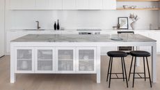 modern kitchen with marble island bench and mesh cupboards