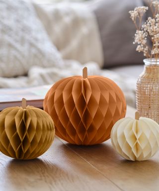 decorating with pumpkin ideas, paper pumpkins on coffee table, couch in background