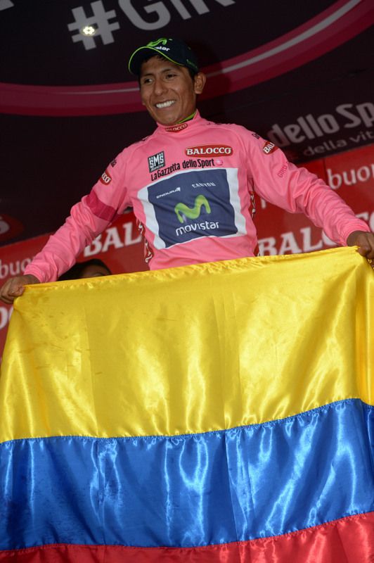 Nairo Quintana brings out a Colombian flag on the podium to celebrate his time trial win in 2014