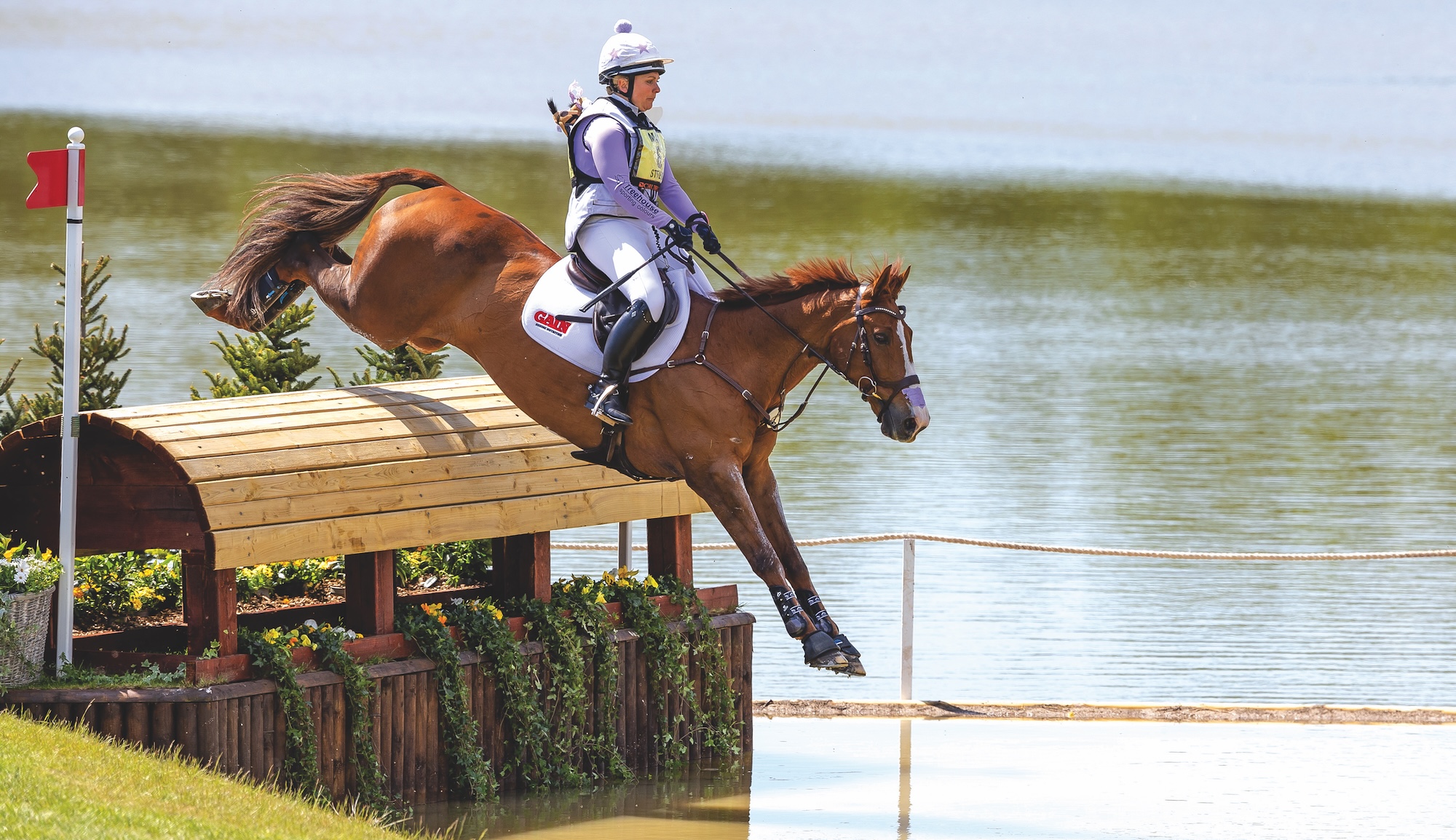 Gemma Stevens and Chilli Knight jump into water across country