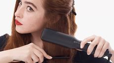 Woman using ghd hair straighteners on her hair