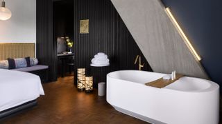 Bedroom with free-standing bath at Nobu Hotel London Shoreditch