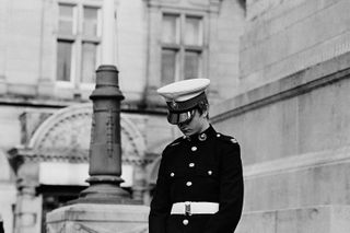 A black & white photo of a person wearing a uniform.