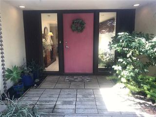 Front of a house with a pink front door