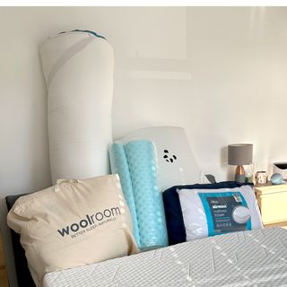 A selection of mattress toppers ready for testing in a bedroom