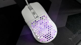 A Glorious Model O Eternal gaming mouse on a mouse mat with the lighting enabled.