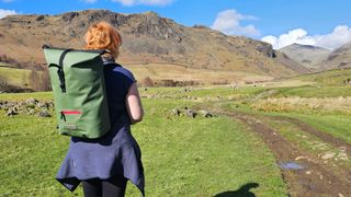 Rosee Woodland using the D-Robe 20L roll-top backpack