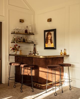 A home bar with metallic tones and brown bar stools