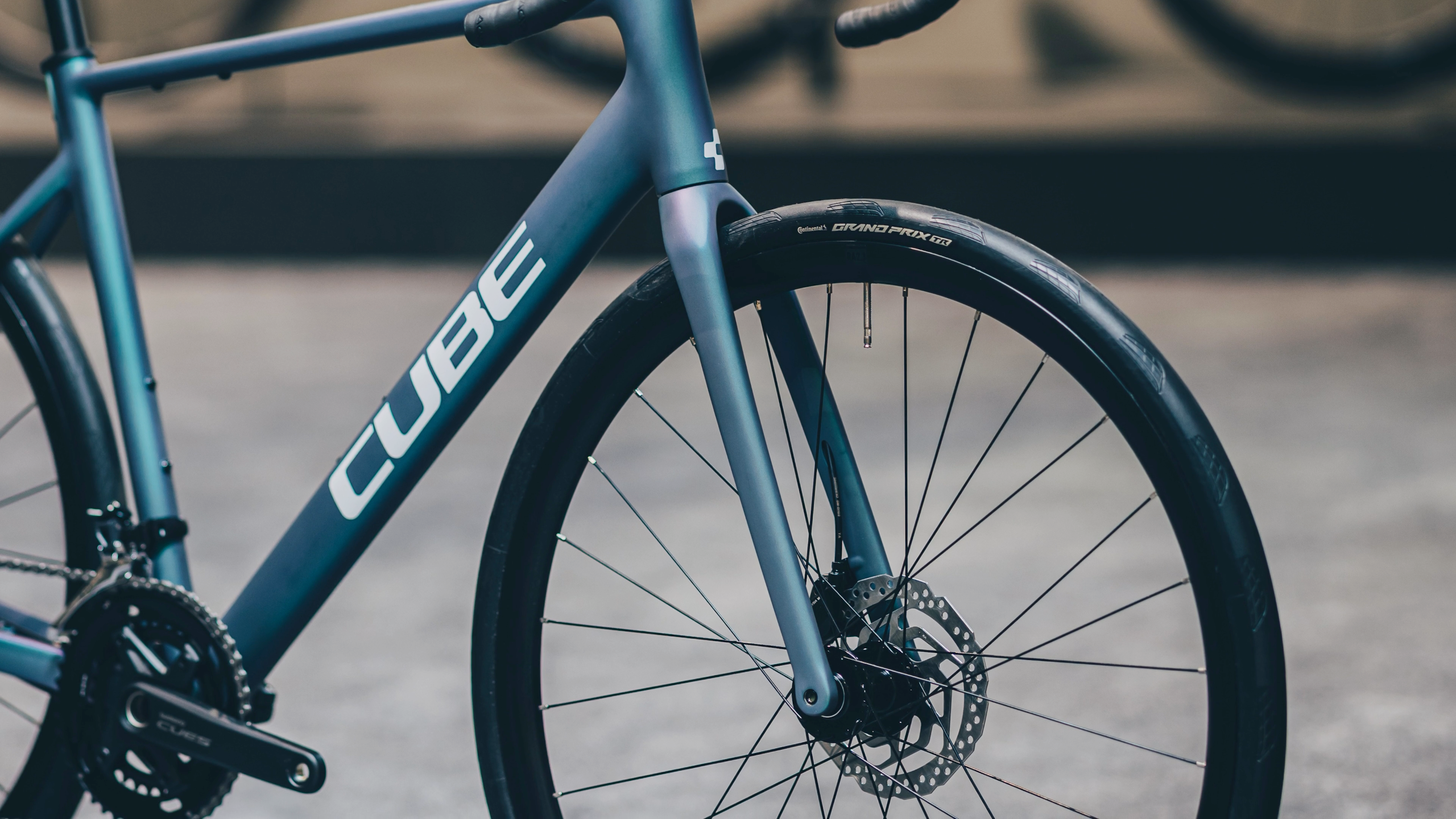 A blue, white and red road bike in an urban environment