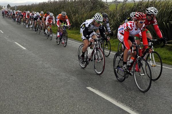 The peloton is strung out in the blustery conditions