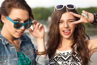 two teenage girls having fun outside