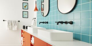 narrow bathroom with blue tiles and orange unit