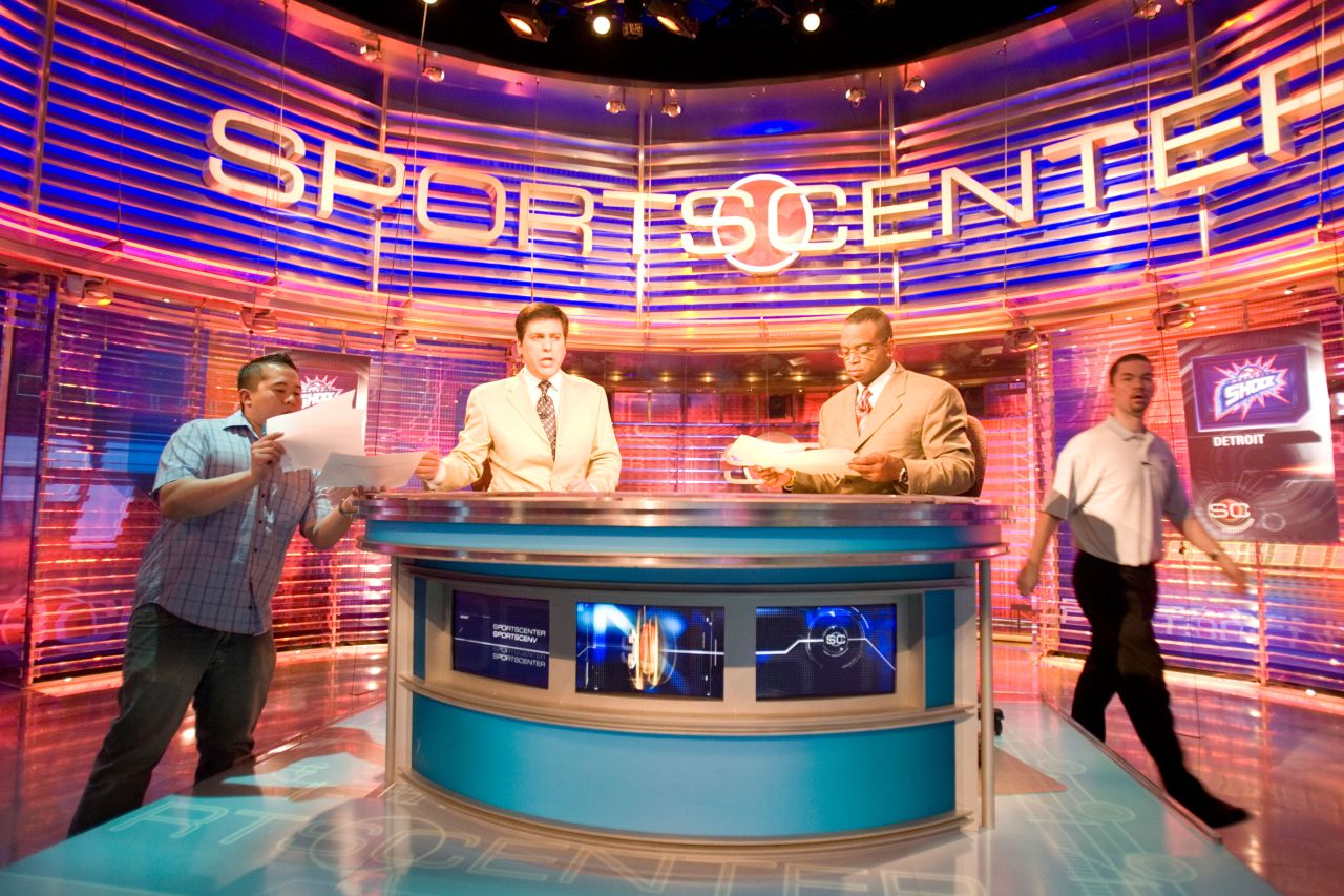 Four men work behind the backdrop inside the Sportscenter TV Studio of ESPN in Bristol Connecticut.