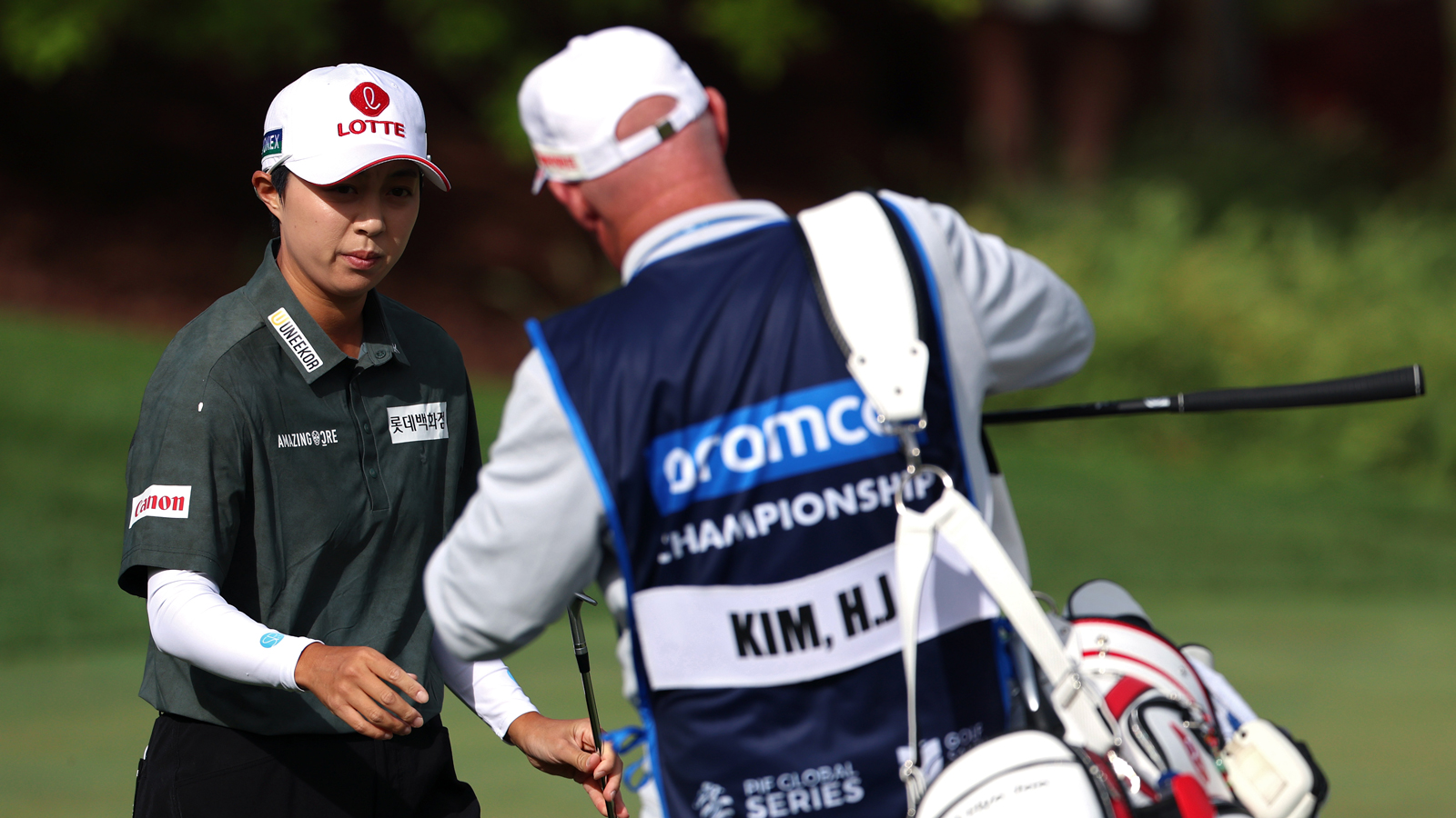 Hyo-Joo Kim walks over to her caddie
