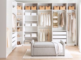 A cozy bedroom with white walls and a closet,