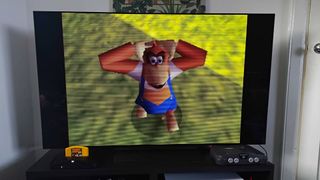 Analogue 3D with CRT filter enabled, connected to LG OLED C4 TV with Donkey Kong 64 gameplay on screen featuring Lanky Kong.