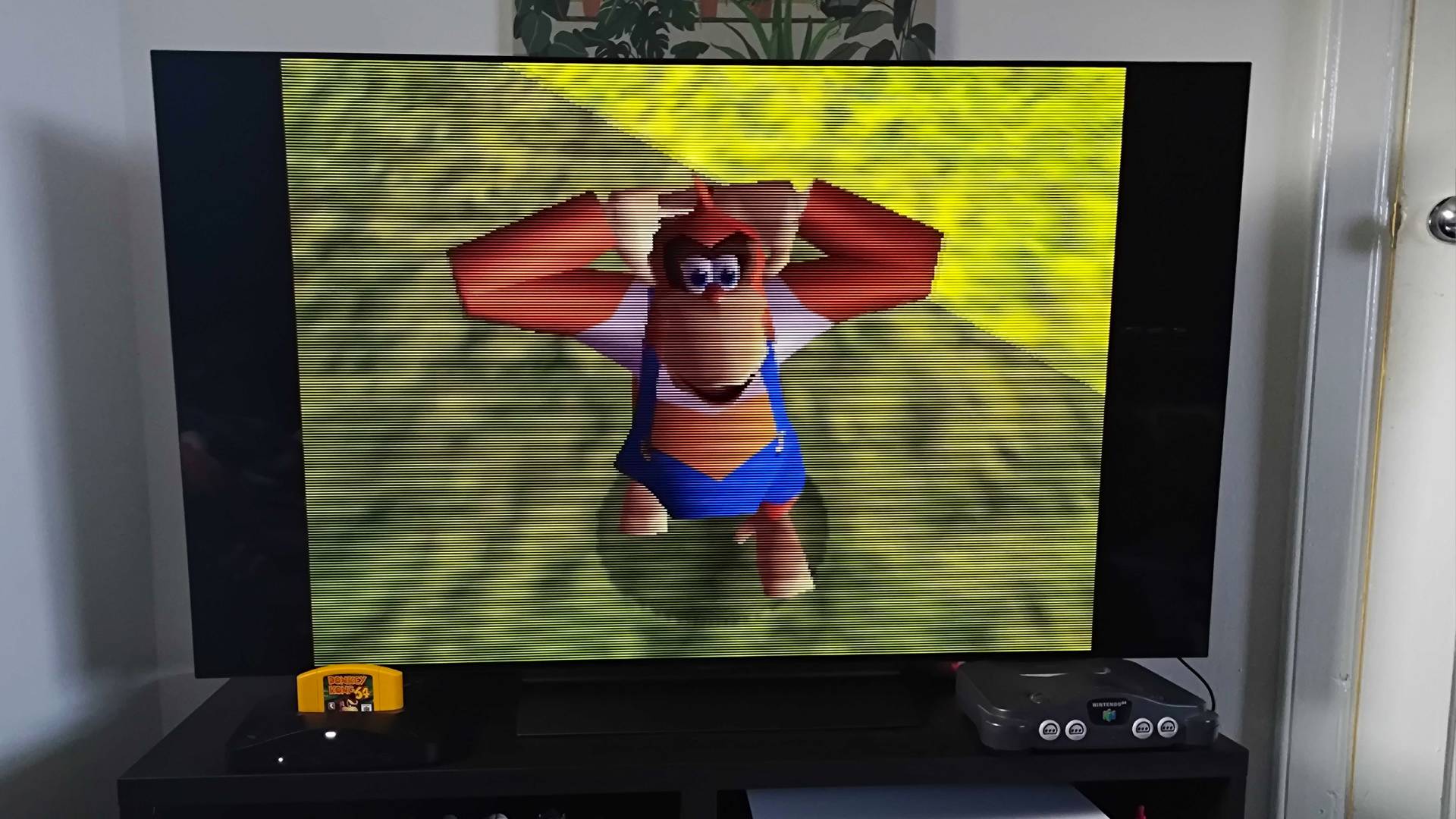 Analogue 3D with CRT filter enabled, connected to LG OLED C4 TV with Donkey Kong 64 gameplay on screen featuring Lanky Kong.