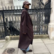 @nlmarilyn wears a brown coat from The Frankie Shop
