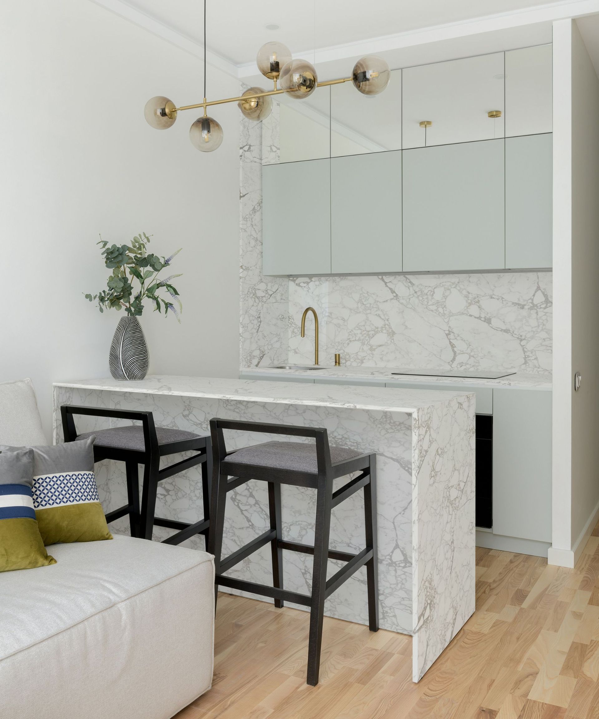A white and gray kitchen with quartz countertops