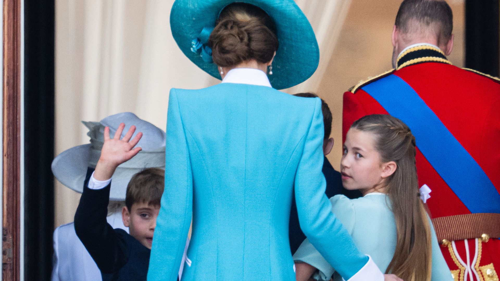 Prince Louis turns and waves as the royals leave the Buckingham Palace balcony