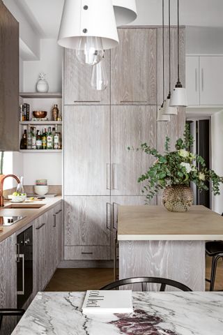 Grey wooden kitchen with marble countertop