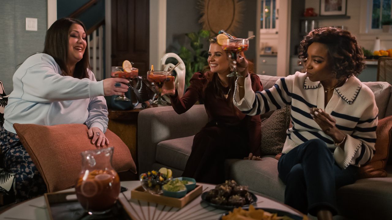 Brooke Elliott as Dana Sue Sullivan, JoAnna Garcia Swisher as Maddie Townsend, Heather Headley as Helen Decatur drinking margaritas on the couch in sweet magnolias