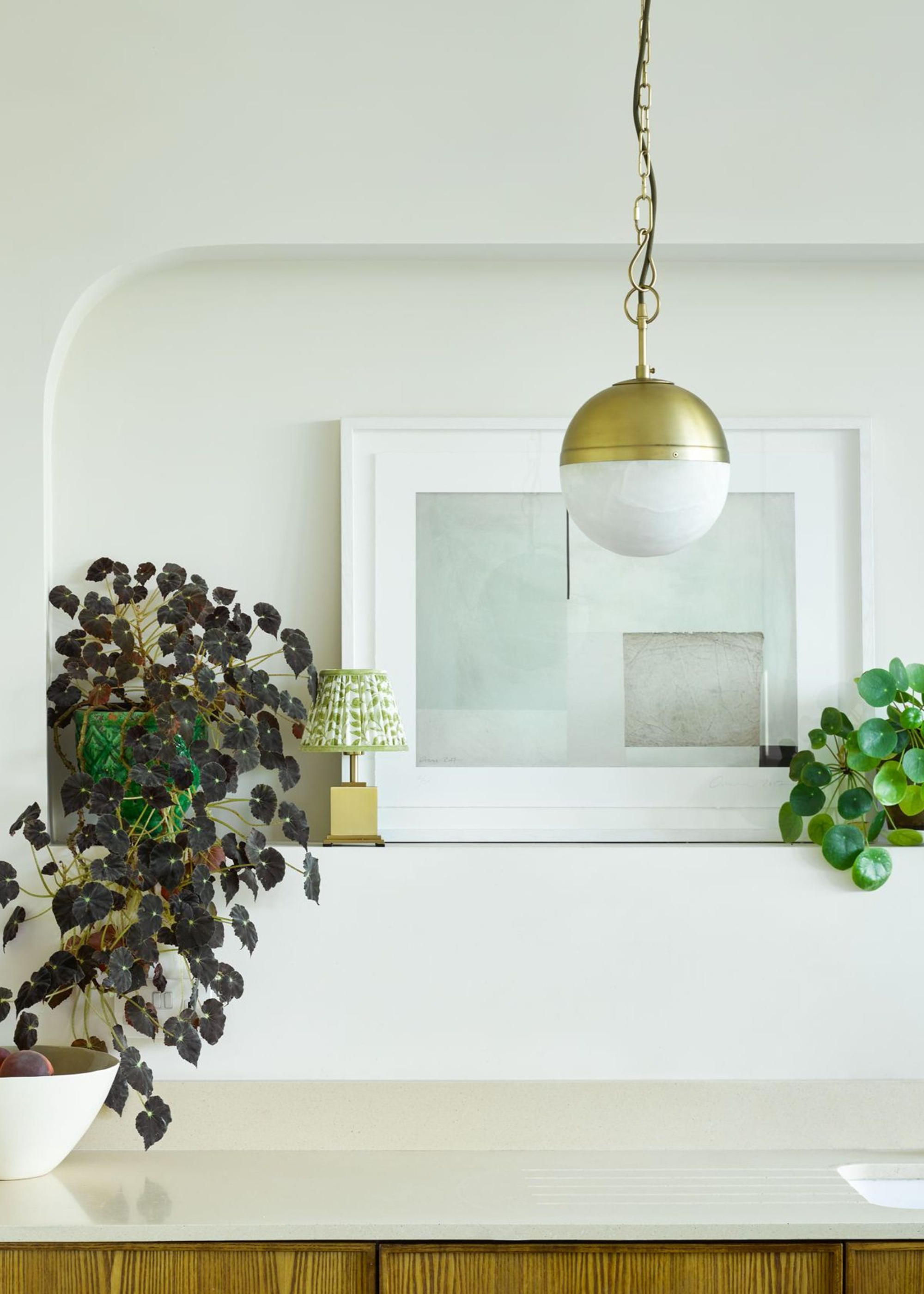 a pendant in antique brass and alabaster in a kitchen