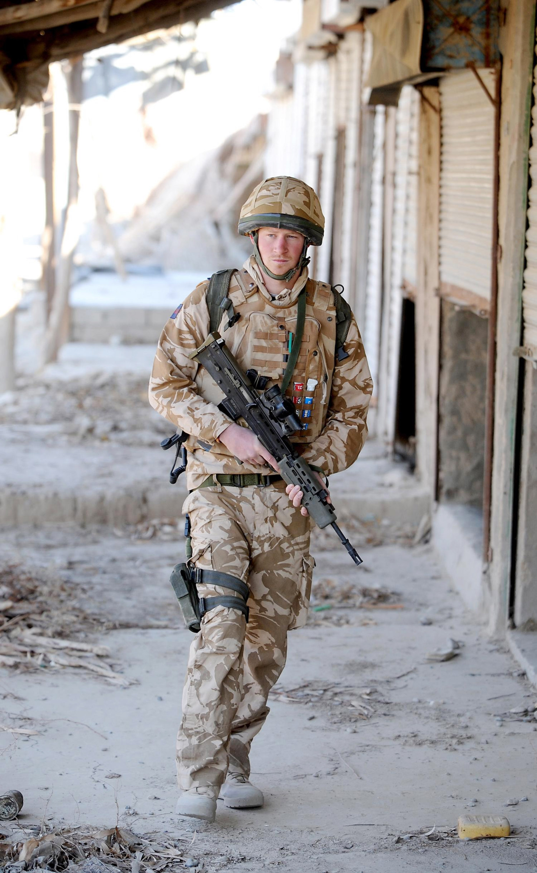 Prince Harry holds a rifle on patrol through the deserted town of Garmisir where he was posted in Helmand province on January 2, 2008 in Southern Afghanistan