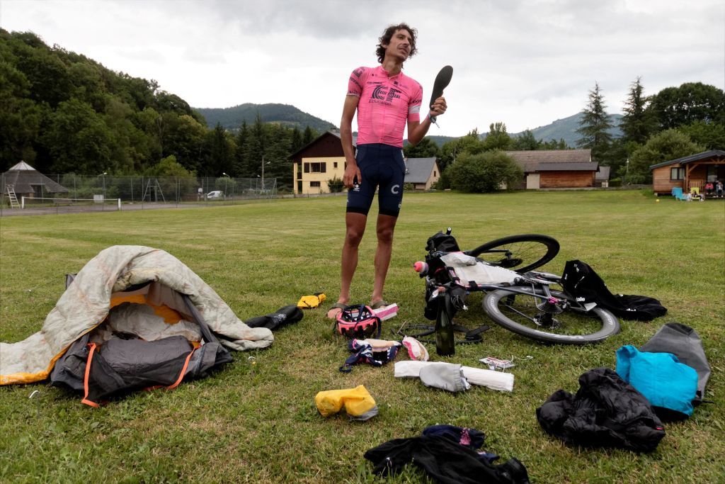 Australian cyclist Lachlan Morton sets up his bivouac at the end of the 13th day of his solo alternative Tour de France cycling race at the Les Vignes camping site in the village of CastillonenCouserans on July 8 2021 Lachlan Morton is riding every kilometer of the Tour de France plus the distances between race starts and finishes solo He stops at cafes for his food and sleep under the stars at night Morton is racing to raise money for World Bicycle Relief Photo by VALENTINE CHAPUIS AFP Photo by VALENTINE CHAPUISAFP via Getty Images
