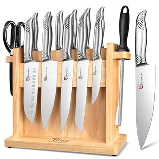 A set of stainless steel kitchen knives with a magnetic wooden knife holder display