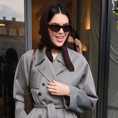 Kendall Jenner was spotted outside the Schiaparelli in a gray coat, a burgundy hair scarf, and socks with loafers