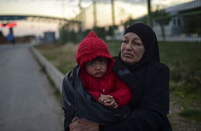 A Syrian refugee with her grandson