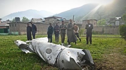 Villagers in India-administered Kashmir examine fighter jet section after skirmish with Pakistan