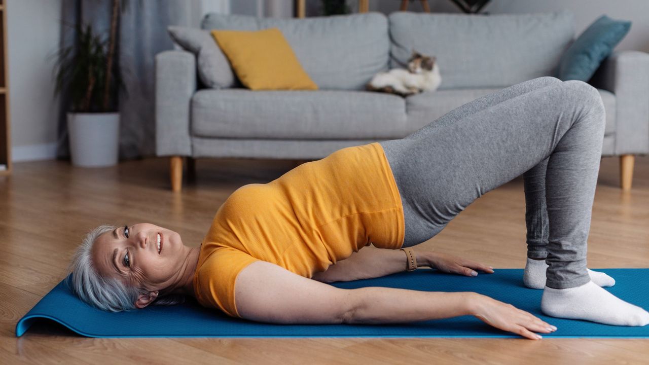 woman in yoga / pilates bridge pose on yoga mat