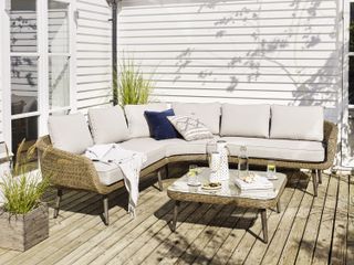 decked terrace with a corner sofa and matching coffee table